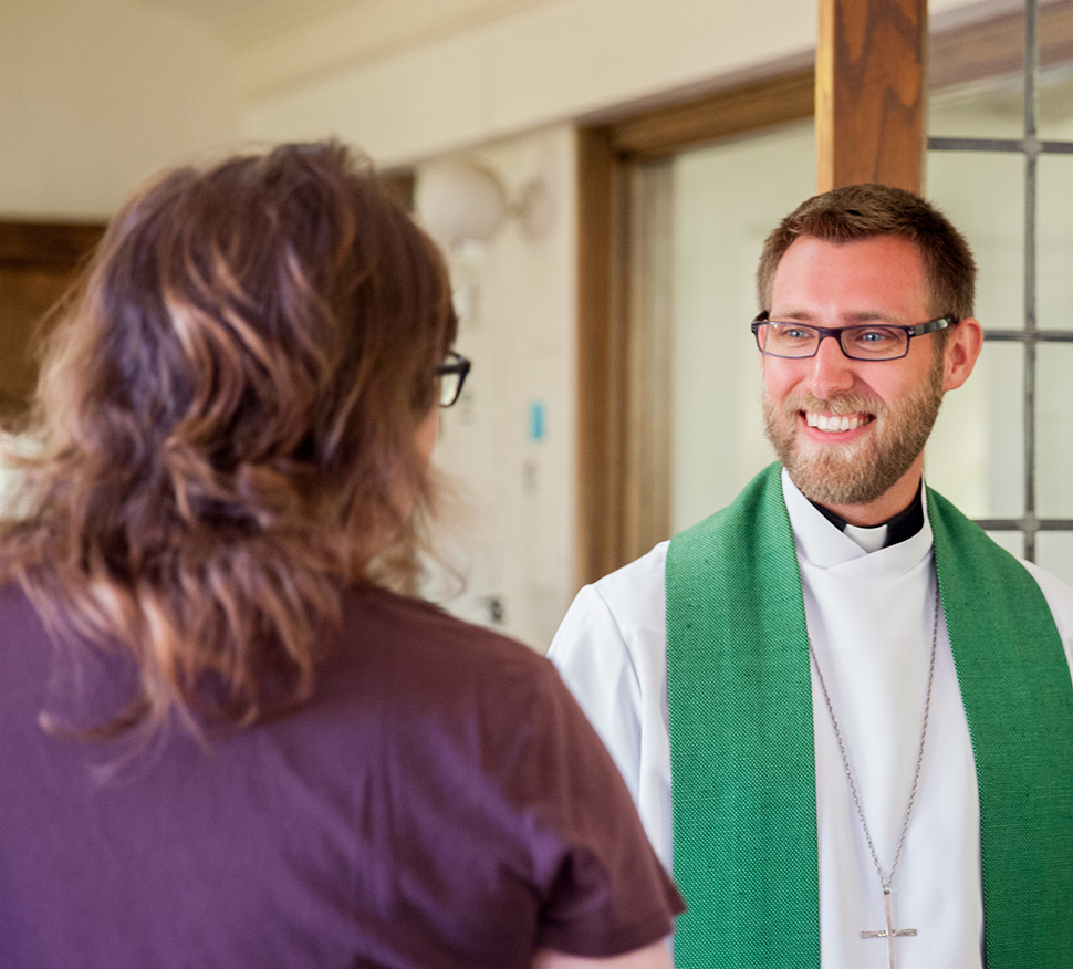 Pastor greets a member at church