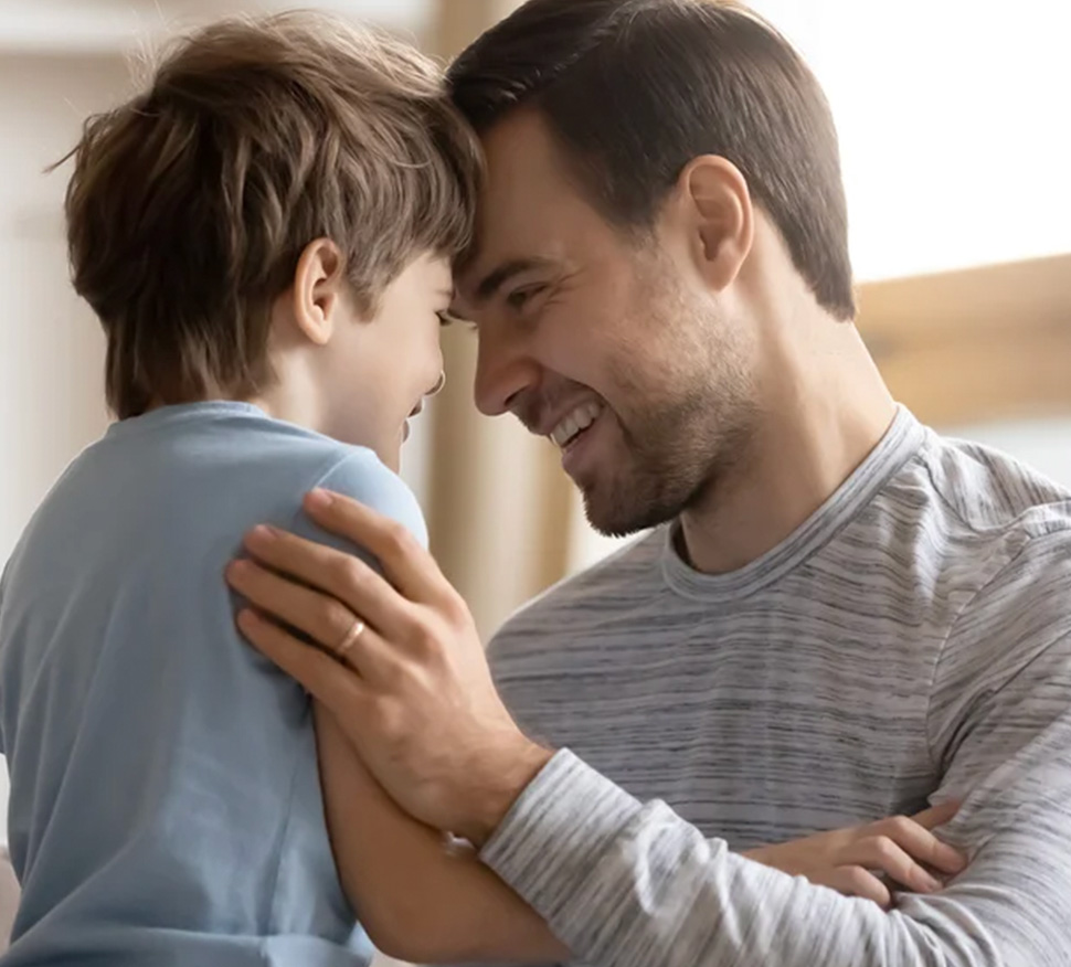 Father embracing young child