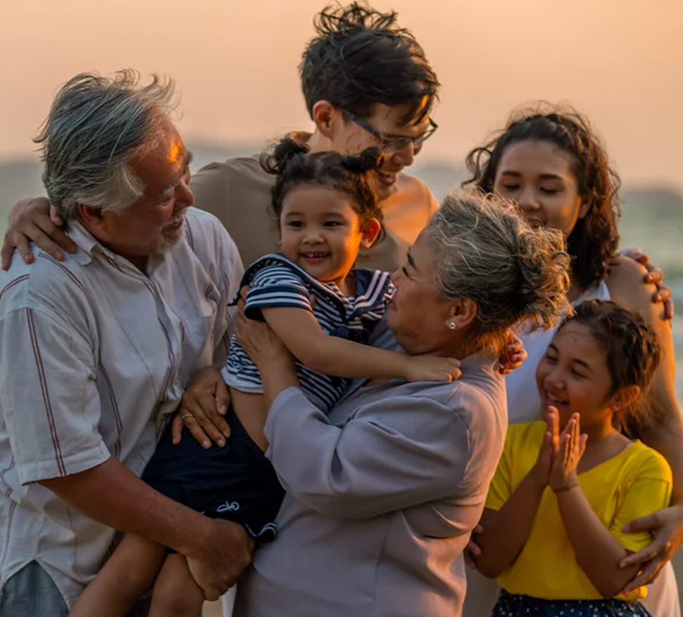 Happy intergenerational family members at beach