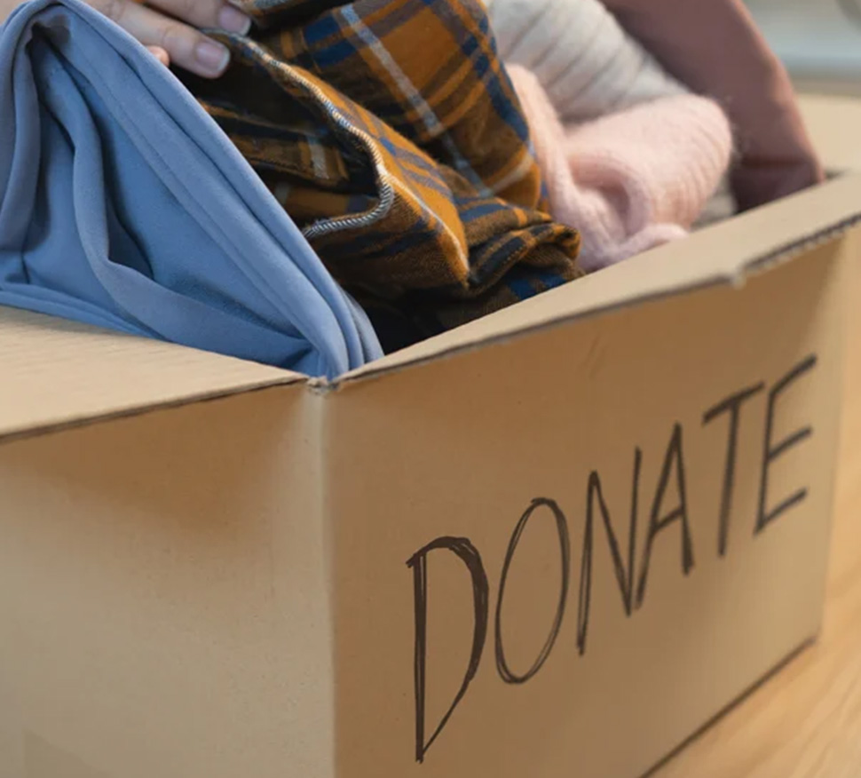 Woman donating clothing to a charity organization