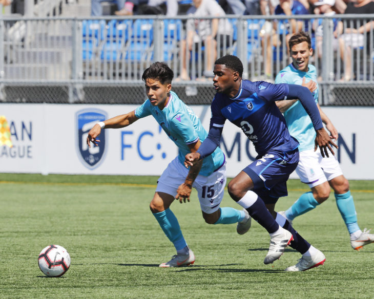 May 12, 2019; Edmonton, Alberta, CAN; Pacific FC attacker Jose Hernandez (15) and FC Edmonton defender Kareem Moses (12) chase after a loose ball during a Canadian Premier League soccer match at Clarke Stadium. Mandatory Credit: Perry Nelson-USA TODAY Sports for CPL