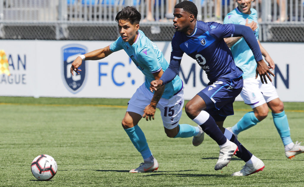 Pacific FC attacker Jose Hernandez and FC Edmonton defender Kareem Moses chase after a loose ball during a CPL match at Clarke Stadium. (Perry Nelson-USA TODAY Sports for CPL).