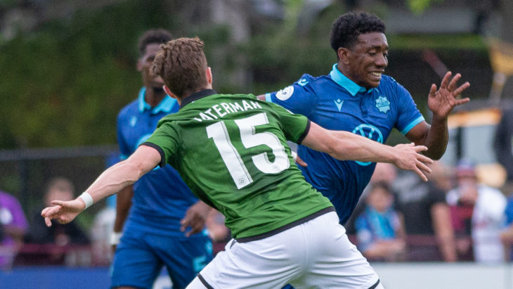 HFX Wanderers FC Attacker Akeem Garcia (11) plays the ball past CavalryFC Midfielder Joel Waterman (15). (Trevor MacMillan/CPL)