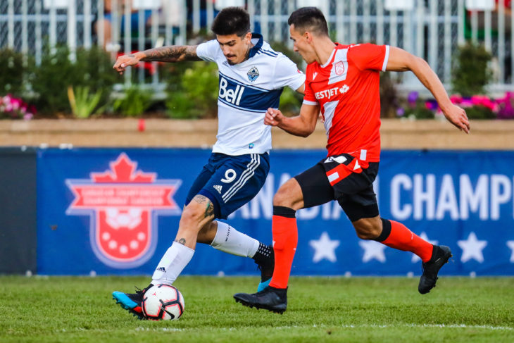 Jul 10, 2019; Calgary, Alberta, USA; Vancouver Whitecaps forward Joaquin Ardaiz (9) and Cavalry FC defender Dominick Zator (4) battle for the ball during the second half of a Canadian Championship soccer match at Spruce Meadows. Mandatory Credit: Sergei Belski-USA TODAY Sports for CPL