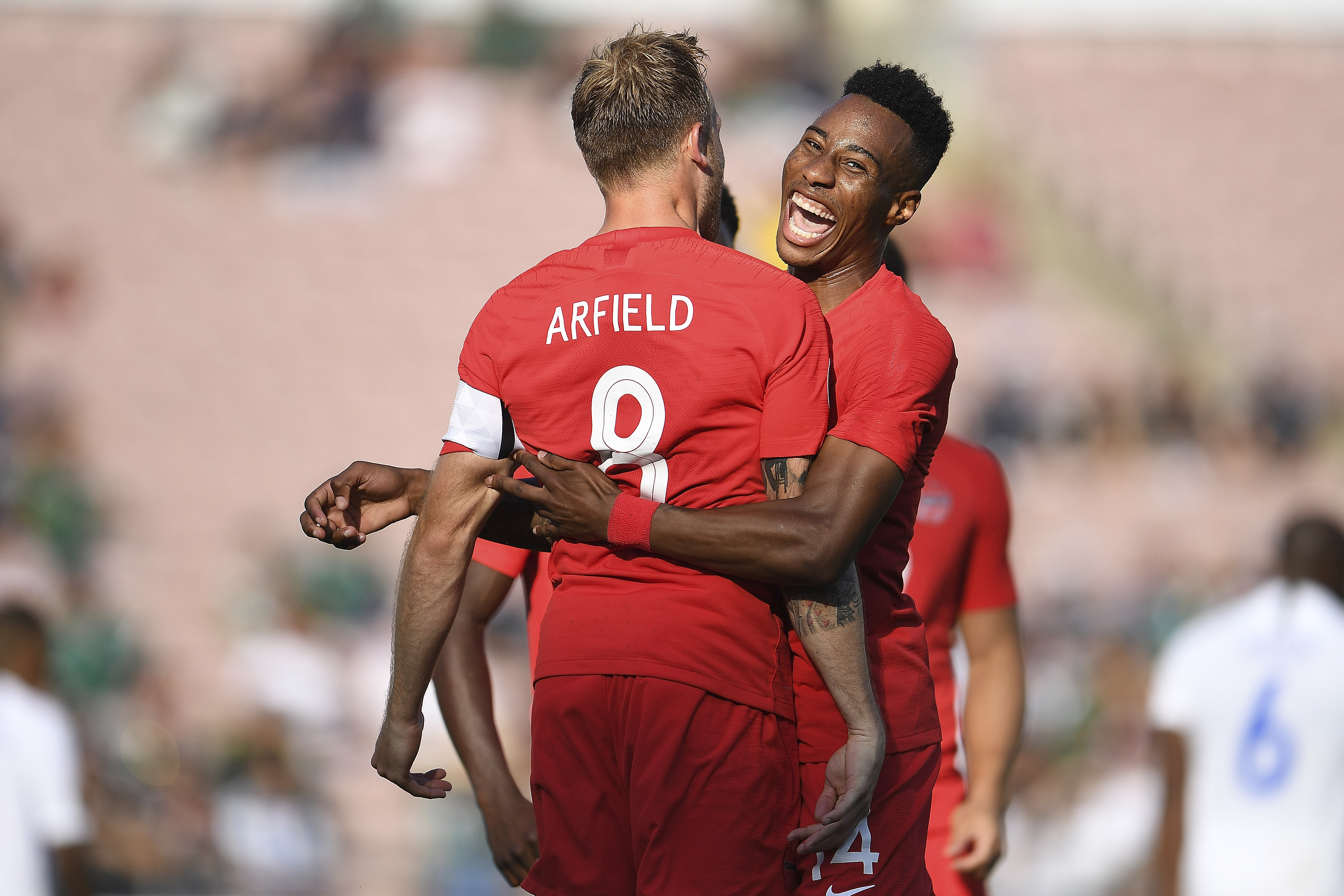 Mark-Anthony Kaye celebrates with Scott Arfield. (Canada Soccer).