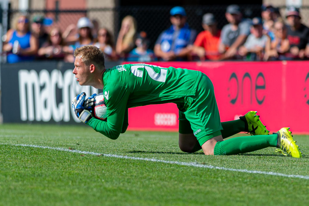 Canadian Premier League - HFX Wanderers FC vs Valour FC - Wanderers Grounds, Halifax, Nova Scotia - August 5, 2019. Valour FC Goalkeeper Mathias Janssens (26) scoops up a shot on goal. (Trevor MacMillan/CPL)