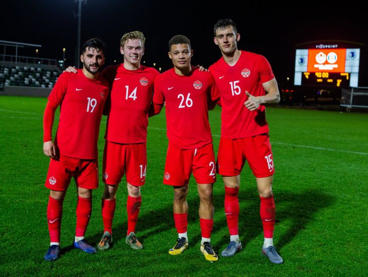 Tristan Borges, Jacob Shaffelburg, Zorhan Bassong and Amer Didic pose after Friday's win over Barbados. (Canada Soccer photo)