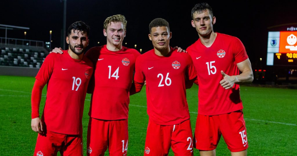 Tristan Borges, Jacob Shaffelburg, Zorhan Bassong and Amer Didic pose after Friday's win over Barbados. (Canada Soccer photo)