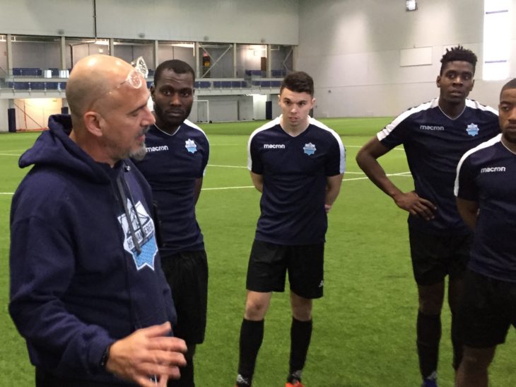 Christian Oxner taking in instructions from coach Stephen Hart during preseason training.