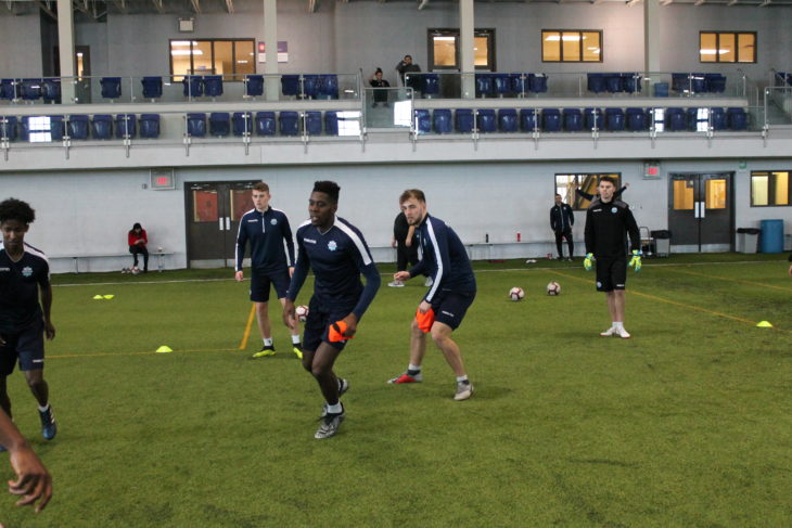 André Bona and Peter Schaale chasing down the ball in a keep away drill in training.