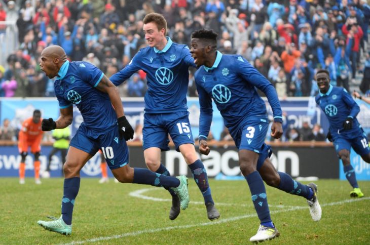 André Bona and Scott Firth share the winning goal celebration with Luis Alberto Perea. Photo: Trevor MacMillan.