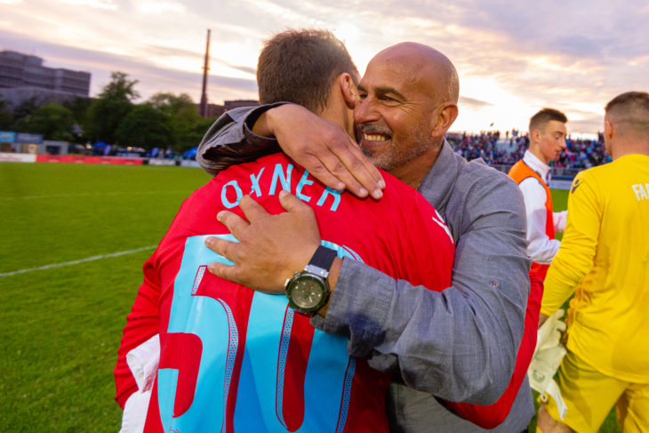 Oxner shares a hug with coach Stephen Hart after shutting out Valour and leading the Wanderers to a 2-0 home win in June. Photo: Trevor MacMillan.