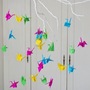 A baby mobile made from colorful paper cranes