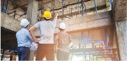 About Us: a team of engineers inspecting a building