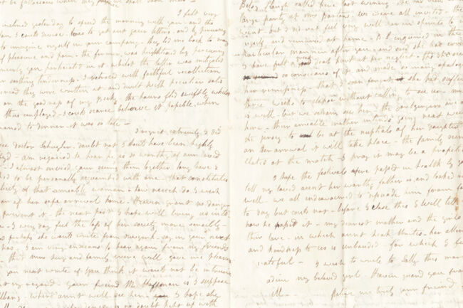 A close-up of an old handwritten letter with faded brown ink on aged, creased paper.