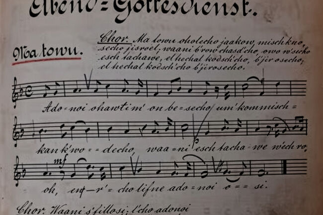 Sheet music with handwritten Czech lyrics and musical notes on a vintage, slightly aged paper.