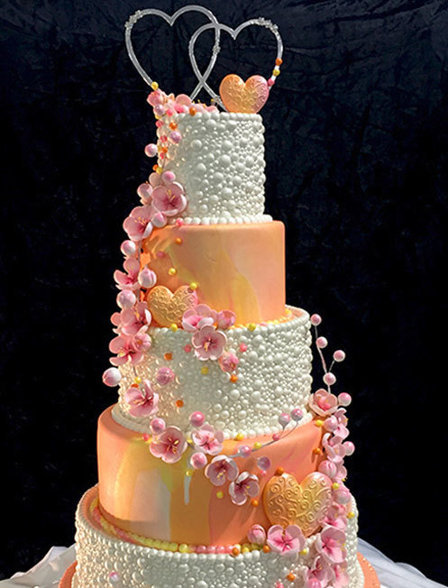 Cake Decorator Spotlight Orange White Heart Tiered Cake