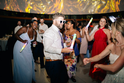 a reception being held in the great hall with party goers dancing