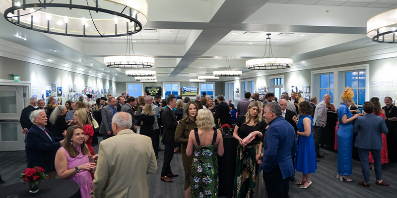 guests chatting at a 2nd floor gallery event