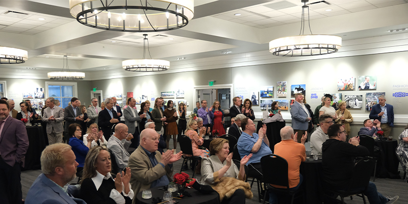 guests clapping at a 2nd floor gallery event