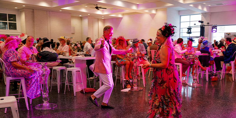 guests dancing in pink lighting in the oaks terrace room