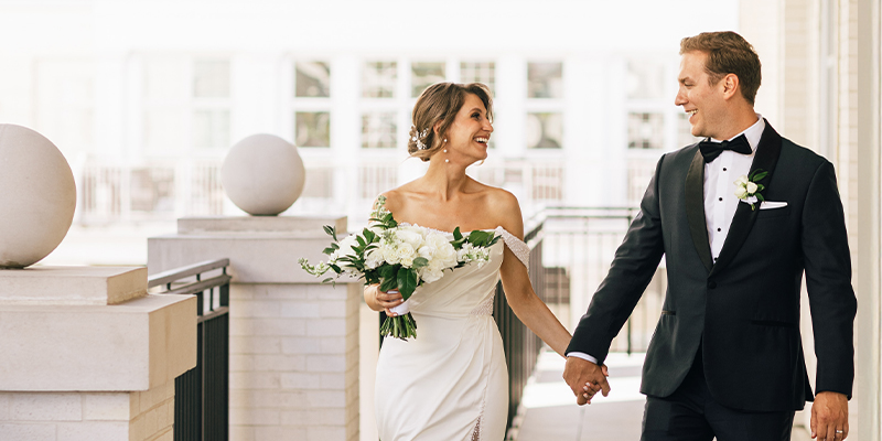 couple holding hands at the balcony on the 2nd floor gallery
