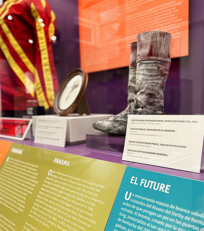 Close up of artifacts and text panel in the A Las Carreras! exhibit