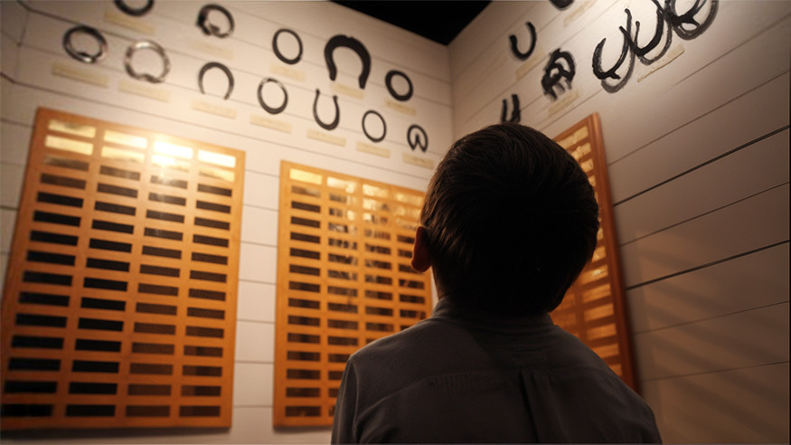 child staring at horseshoe wall