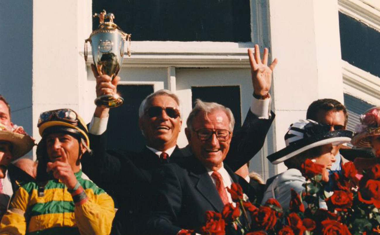 Trainer D. Wayne Lukas holding a gold cup in the Winner's Circle for the forth time in 1999. Photo courtesy of Churchill Downs Racetrack