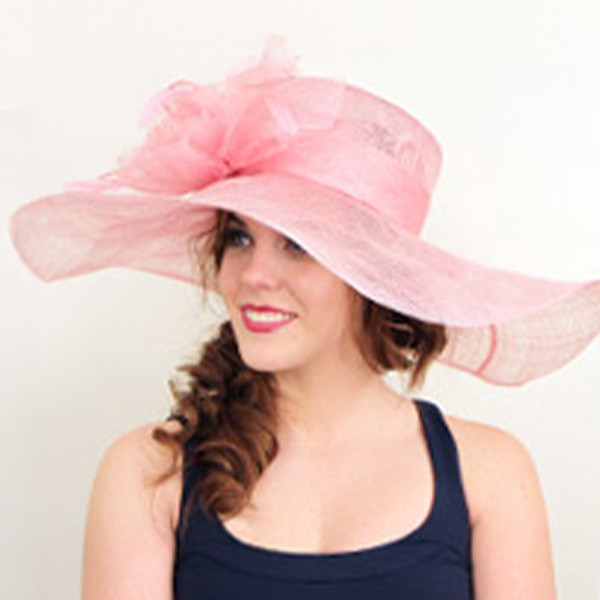 woman wearing a pink derby hat