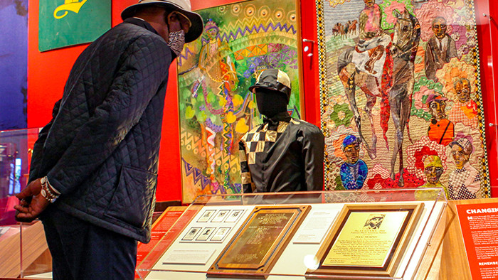 man standing by the black heritage in racing exhibit