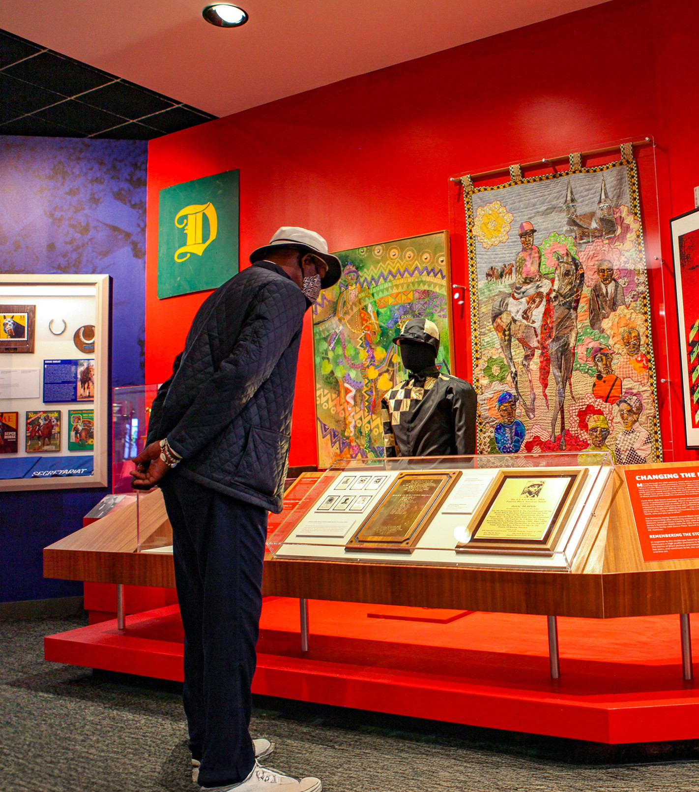 man standing by the black heritage in racing exhibit