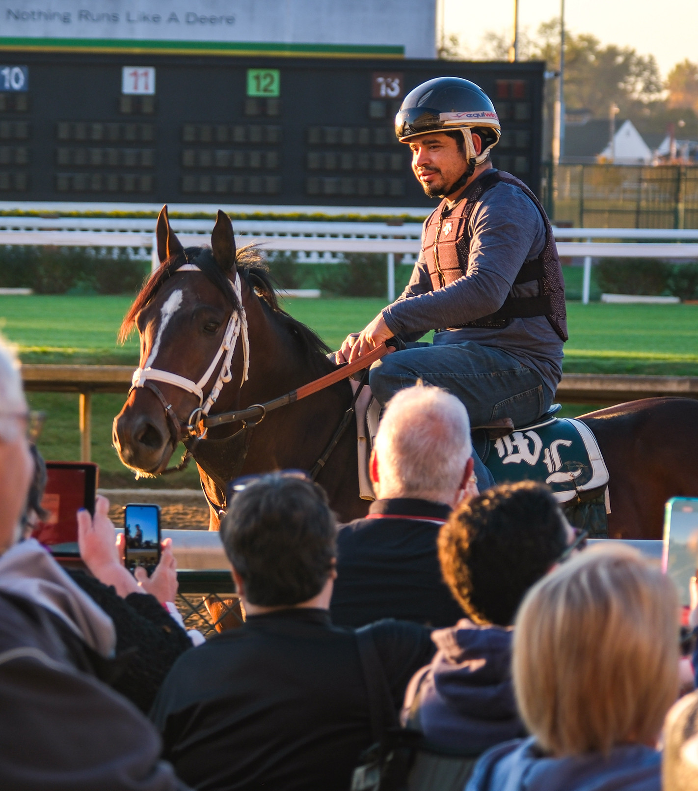 jockey on horse greeting visitors