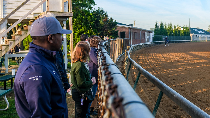 group on a tour watching the backstretch workout