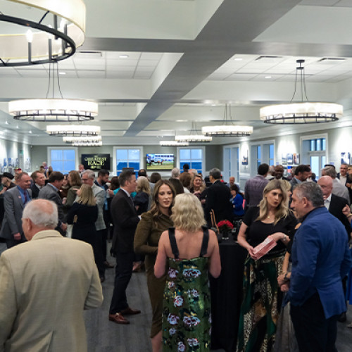 guests chatting at a 2nd floor gallery event
