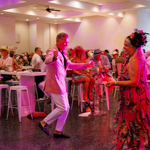 guests dancing in pink lighting in the oaks terrace room