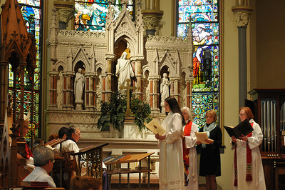 Ordinand Meghan Holland stands before seated Bishop Terry Allen White 