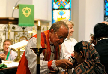 Bishop Gene Robinson shares the chalice with Anita Collins