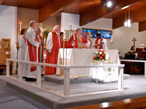 Bishop White, assisted by other clergy, celebrates Eucharist