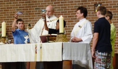Fr. J at altar with kids 1