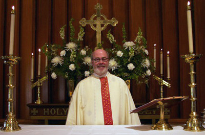 The Rev. Richard Galloway behind the altar at Trinity Church in Fulton