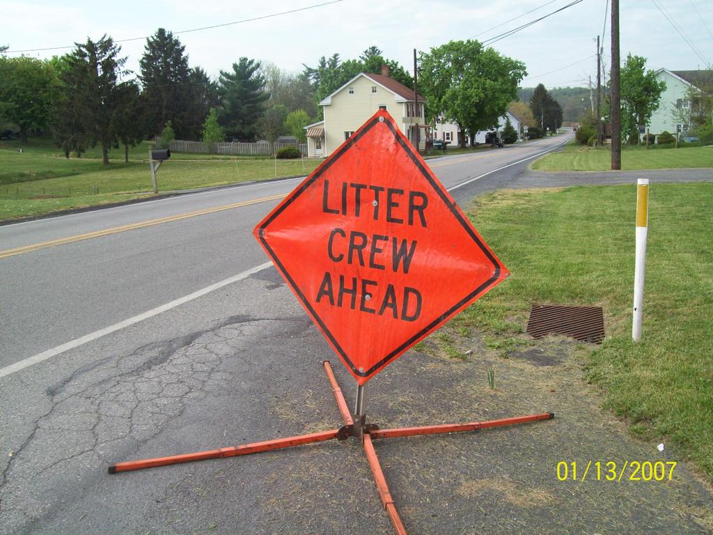 Crew gathering trash bags along the highway