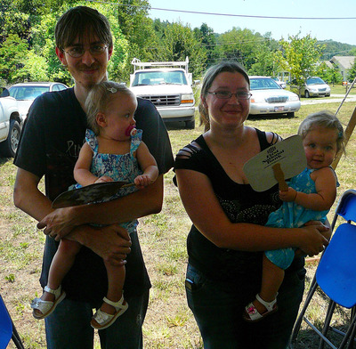 Jason, Alicia, Jazmine and Lily Dalton celebrate at the blessing and dedication of their new home in Hope Haven, Loudon