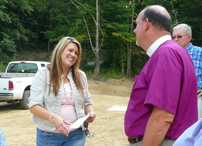 Bishop Young gives contribution to Appalachian Habitat for Humanity to Haley Cross Terry on AMRT 2013 pilgrimage