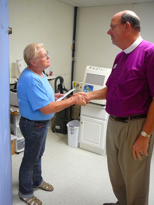 Ella Smith, executive director of the Morgan Scott Project, receives a gift from Bishop Young on 09-10-2013 AMRT pilgrimage to Morgan and Scott Counties 