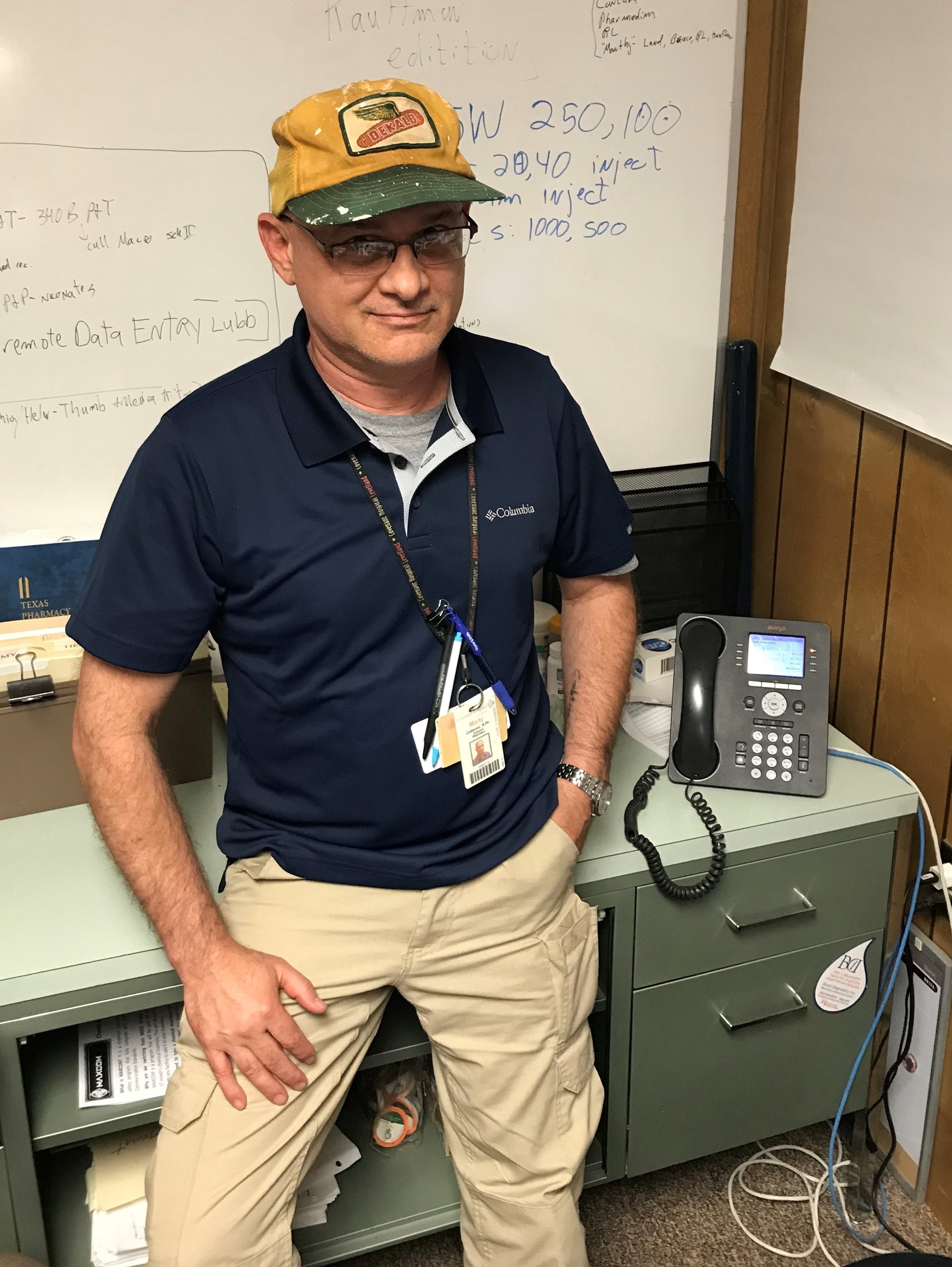 Marty resting from work, leaning on a desk
