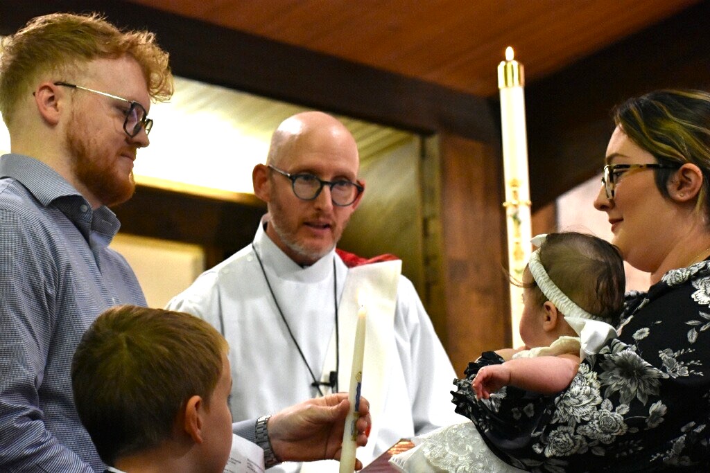 Family receives baptism candle