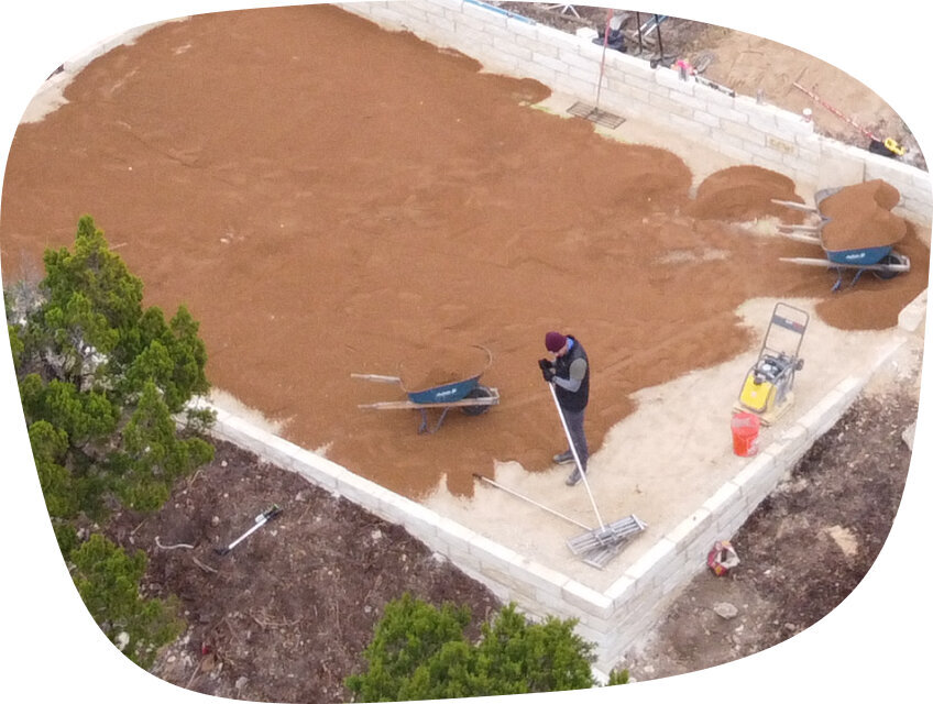 Synthetic grass installation process of land preparation and base setup.