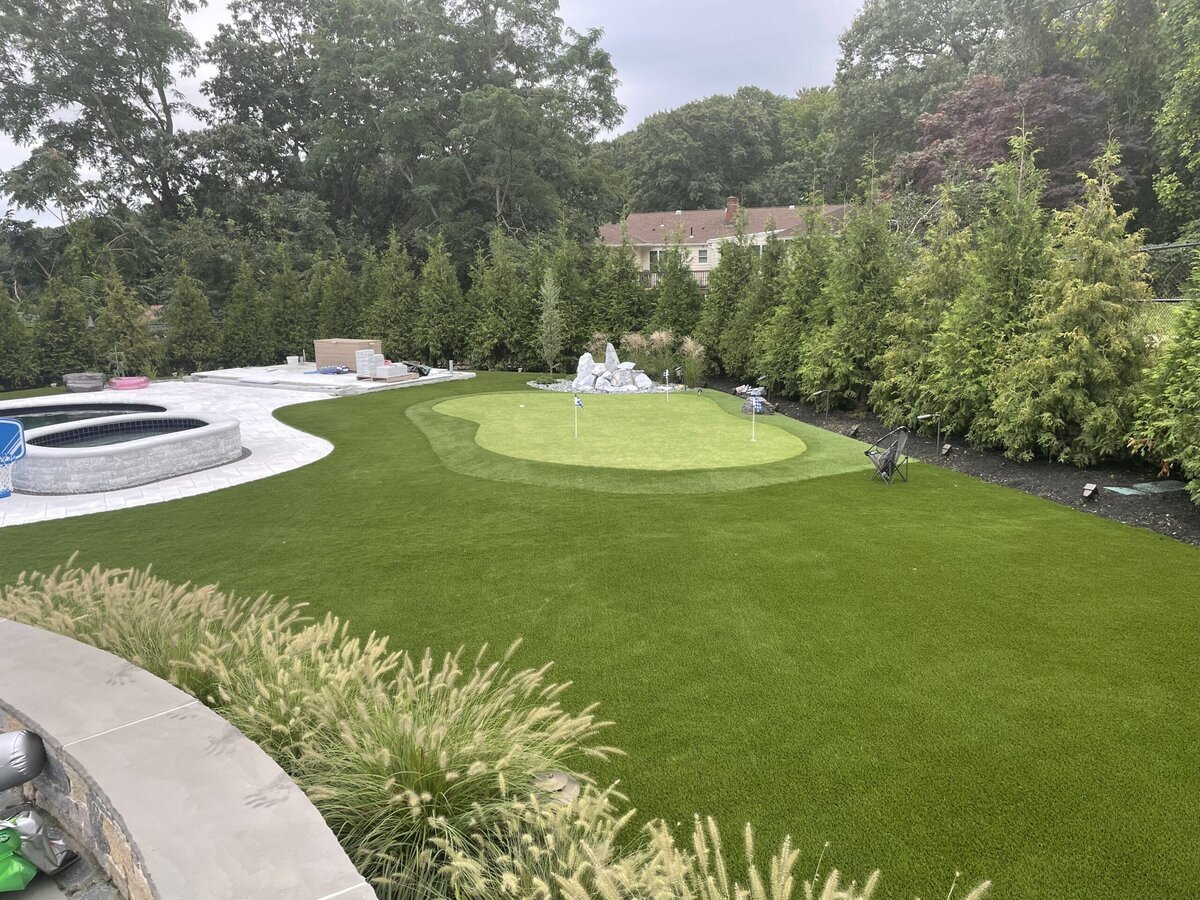 Backyard putting green artificial turf around pool Boston