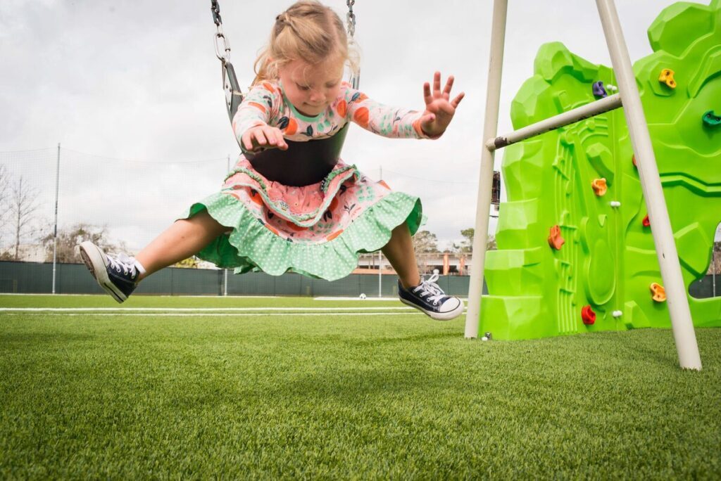 Artificial turf backyard swing set